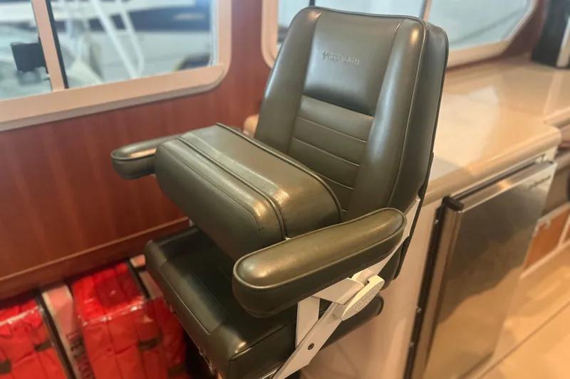 Slide: The Image of Captain's chair on 2007 True North 38 Heritage yacht, featuring leather upholstery and armrests. - 18