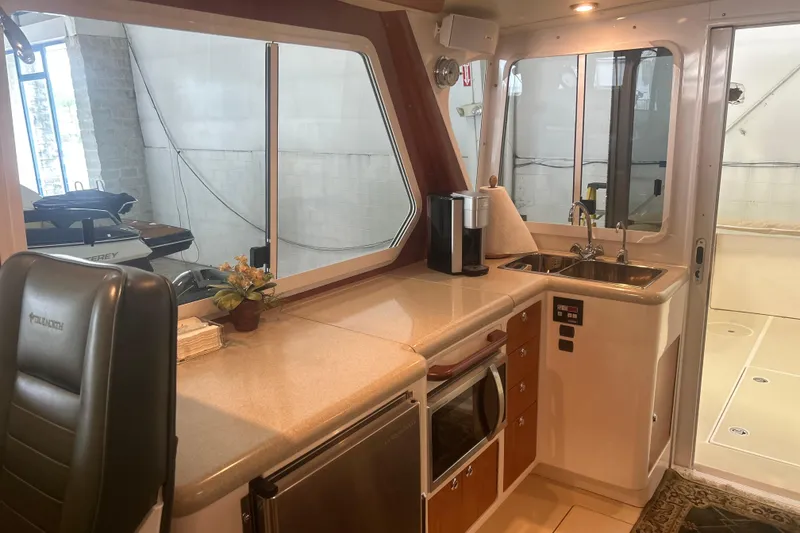 Slide: The Image of Interior of 2007 True North 38 Heritage yacht with kitchenette and seating area. - 19
