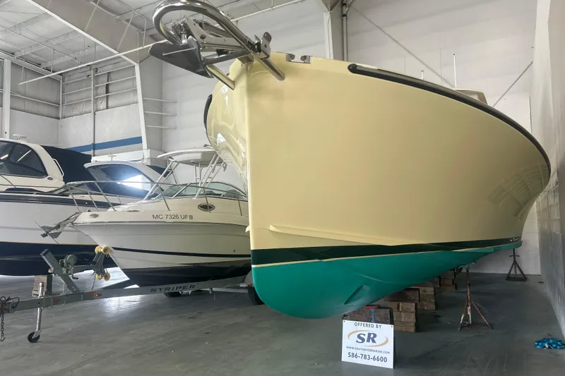 Slide: The Image of 2007 True North 38 Heritage boat in indoor storage, alongside other vessels. - 2