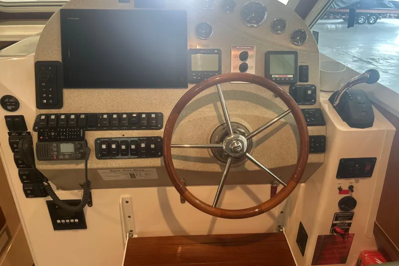 Slide: The Image of 2007 True North 38 Heritage boat helm with wooden steering wheel and control panel. - 22