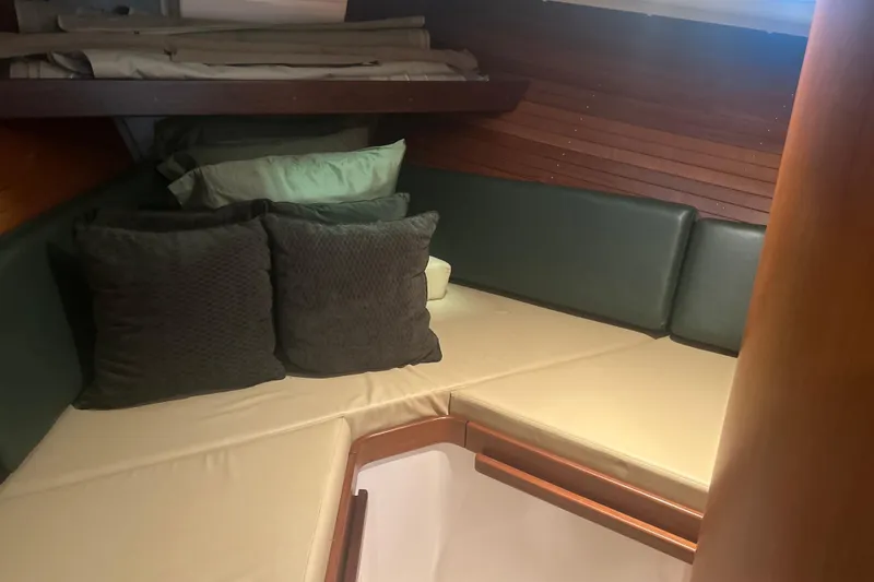 Slide: The Image of Cozy cabin interior of 2007 True North 38 Heritage yacht with cushions and wood paneling. - 25