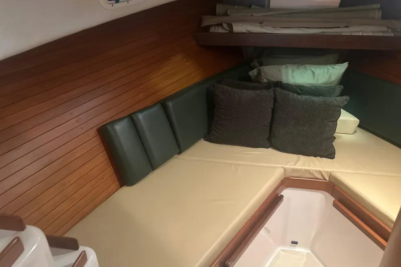 Slide: The Image of Cozy cabin interior of 2007 True North 38 Heritage boat with cushions and wood paneling. - 27