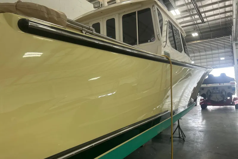 Slide: The Image of 2007 True North 38 Heritage boat in a warehouse, showcasing sleek design and polished finish. - 3