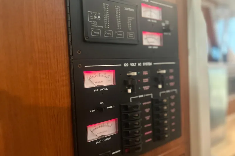 Slide: The Image of Electrical panel of 2007 True North 38 Heritage boat, featuring voltage and current meters. - 31