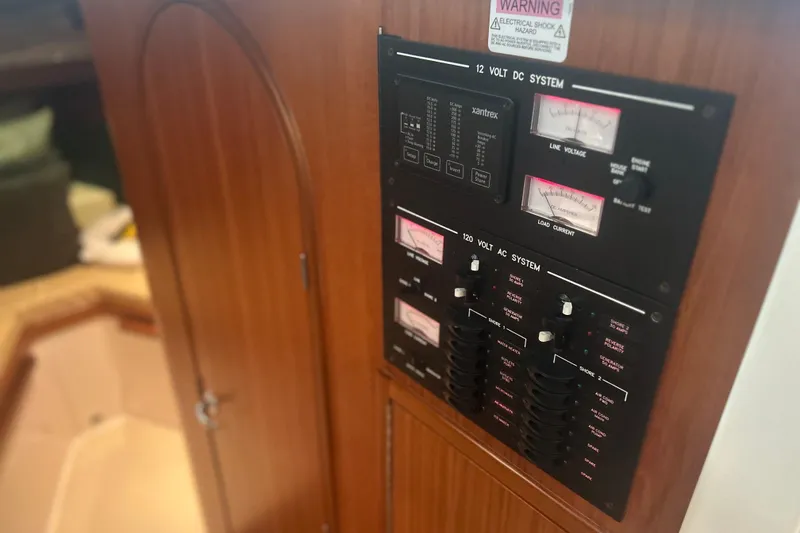 Slide: The Image of Electrical panel on 2007 True North 38 Heritage boat, featuring 12V DC and 120V AC systems. - 32