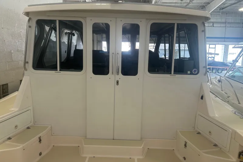 Slide: The Image of 2007 True North 38 Heritage boat interior with closed cabin doors in a showroom. - 35