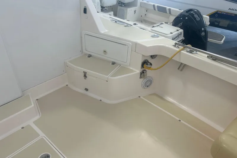 Slide: The Image of 2007 True North 38 Heritage boat interior with storage compartments and engine controls. - 36