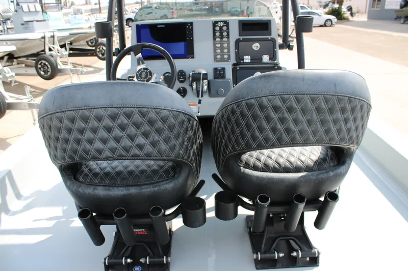 Slide: The Image of Luxury seating and control panel of 2025 Mamba 24 Cat Elite boat. - 17