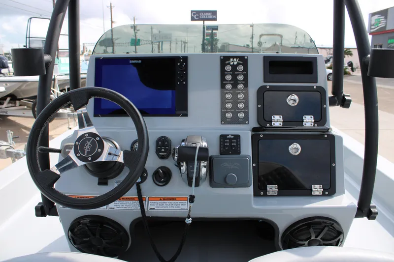 Slide: The Image of 2025 Mamba 24 Cat Elite boat dashboard with steering wheel and control panel. - 18