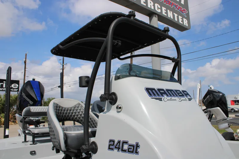 Slide: The Image of 2025 Mamba 24 Cat Elite boat with custom design, featuring sleek seating and modern console. - 22