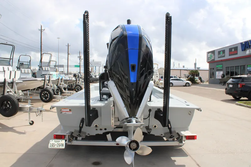 Slide: The Image of 2025 Mamba 24 Cat Elite boat with powerful outboard motor, displayed at a dealership. - 6