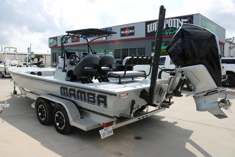 Slide: The Image of 2025 Mamba 24 Cat Elite boat on trailer, displayed at dealership. - 7