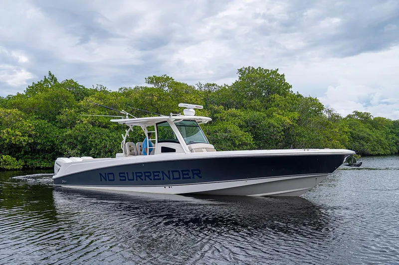 Slide: The Image of 2017 Boston Whaler 370 Outrage boat cruising on a calm river. - 17