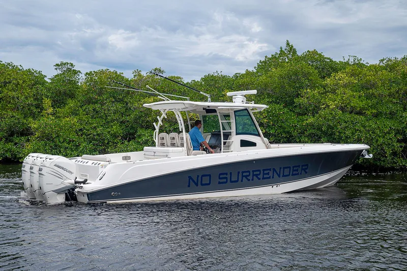 Slide: The Image of 2017 Boston Whaler 370 Outrage boat named "No Surrender" cruising on a calm waterway. - 18