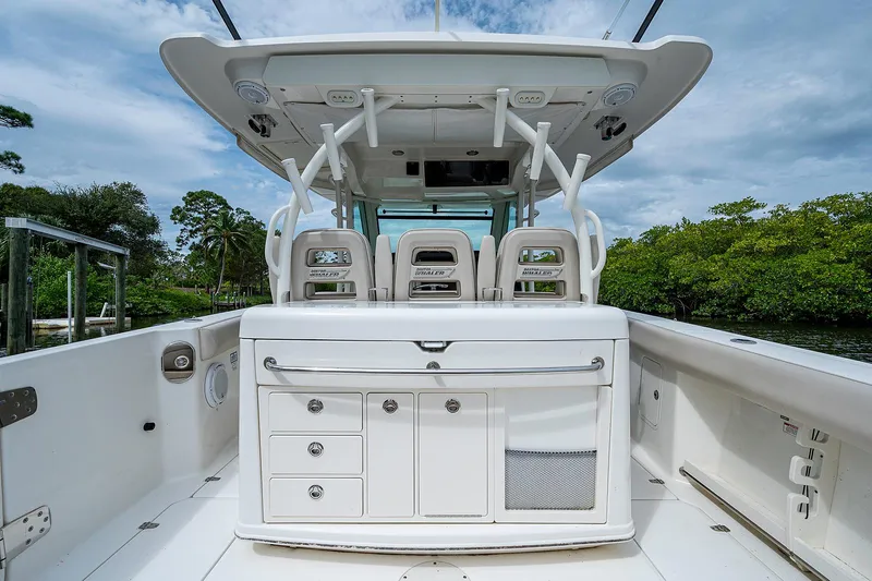 Slide: The Image of 2017 Boston Whaler 370 Outrage boat interior with seating and storage compartments. - 22