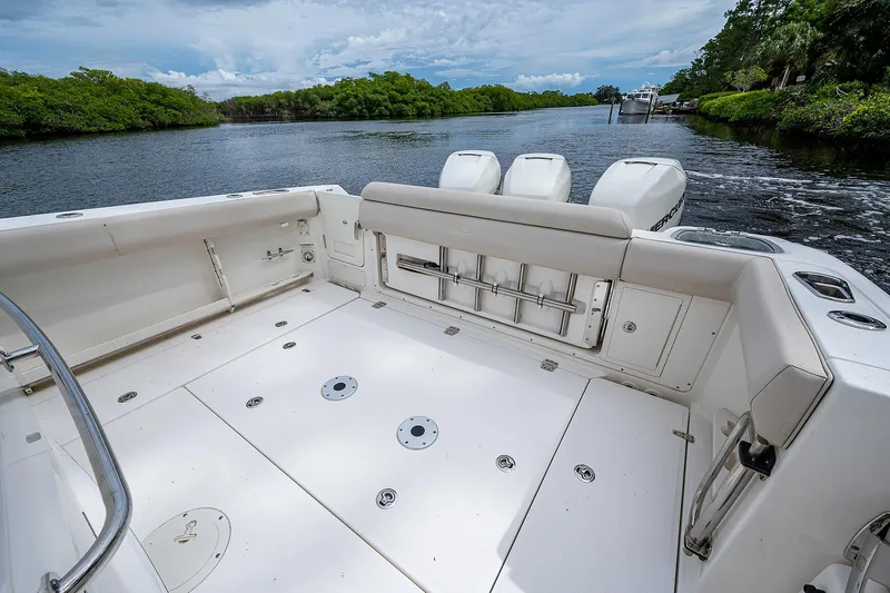 Slide: The Image of 2017 Boston Whaler 370 Outrage boat deck with triple engines on a scenic river. - 28