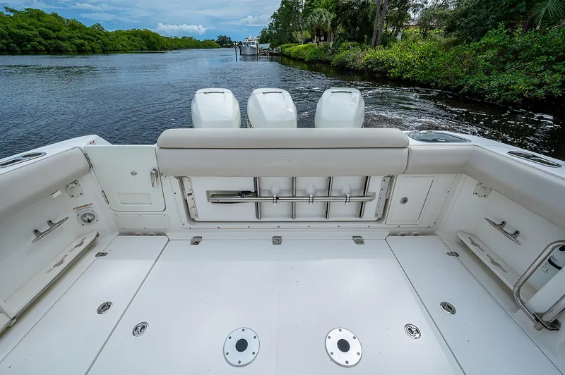 Slide: The Image of 2017 Boston Whaler 370 Outrage boat deck with triple engines on a scenic river. - 29