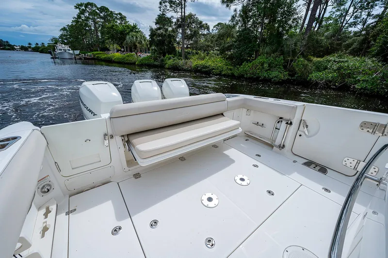 Slide: The Image of 2017 Boston Whaler 370 Outrage boat deck with seating, on a scenic river. - 30