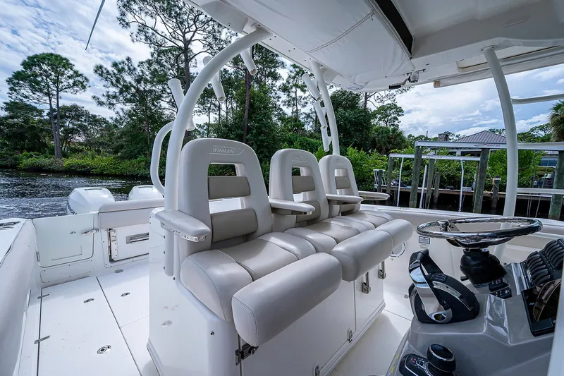 Slide: The Image of Interior view of 2017 Boston Whaler 370 Outrage boat with plush seating and steering console. - 39
