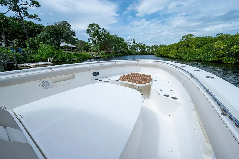 Slide: The Image of 2017 Boston Whaler 370 Outrage boat, spacious deck, scenic river view. - 44