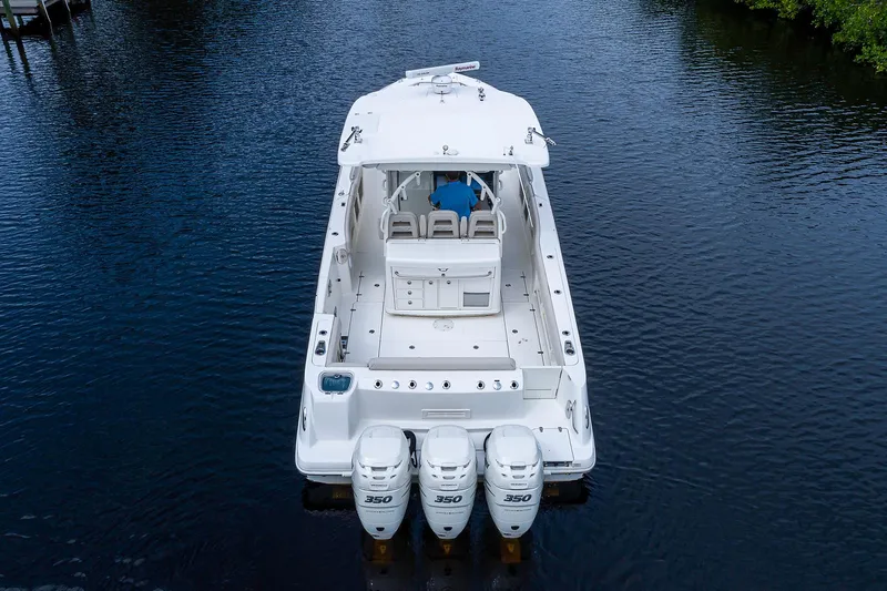 Slide: The Image of 2017 Boston Whaler 370 Outrage boat with triple 350 engines on calm water. - 8