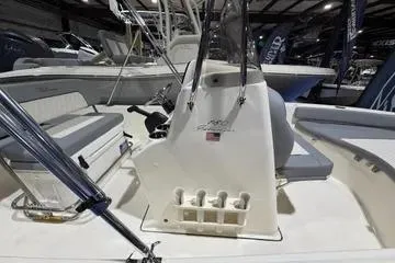 Slide: The Image of 2026 Pioneer 180 Islander boat interior with seating and console in a showroom. - 12