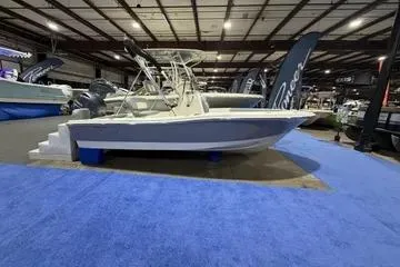 Slide: The Image of 2026 Pioneer 180 Islander boat displayed indoors on blue carpet. - 2