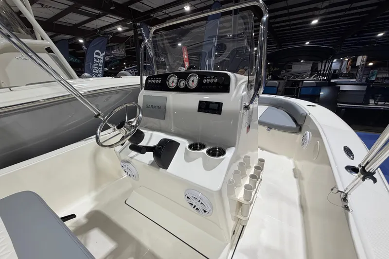 Slide: The Image of 2026 Pioneer 180 Islander boat interior with steering console and Garmin navigation system. - 8
