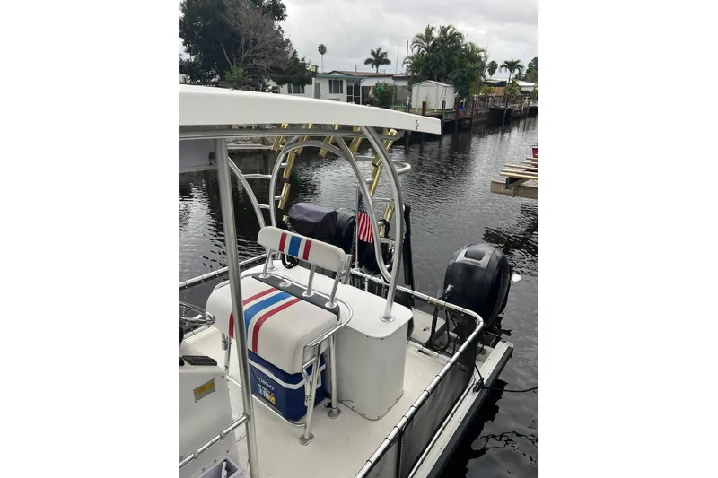 Slide: The Image of 2010 A&M Manufacturing Triton Pontoon boat docked on a calm waterway. - 5