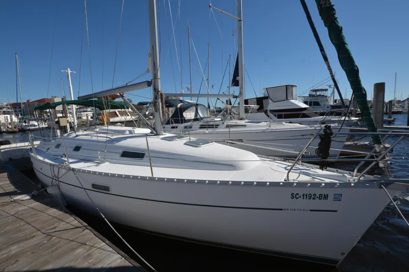 The Image of 2002 Beneteau Oceanis 331 sailboat docked at marina under clear blue sky. - 1