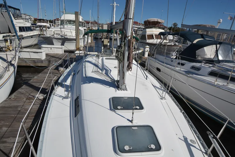 Slide: The Image of 2002 Beneteau Oceanis 331 sailboat docked at marina, surrounded by other boats. - 13
