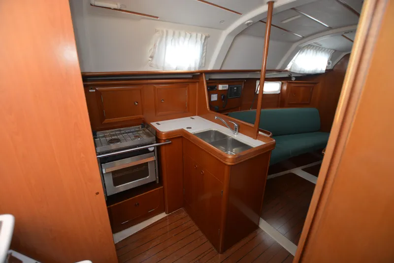 Slide: The Image of Interior of 2002 Beneteau Oceanis 331 yacht with kitchen and seating area. - 8
