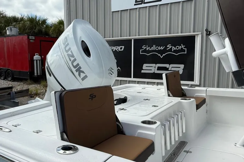 Slide: The Image of 2026 Sea Pro 230 Bay boat with Suzuki engine, docked near a building. - 10