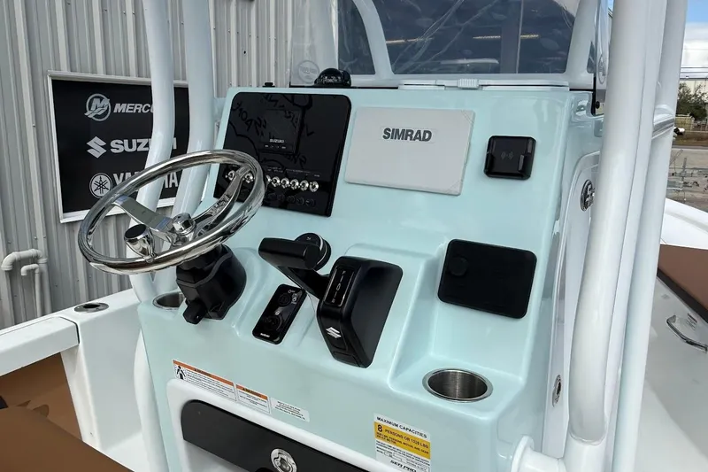 Slide: The Image of 2026 Sea Pro 230 Bay boat console with steering wheel and Simrad electronics. - 11