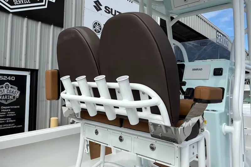 Slide: The Image of 2026 Sea Pro 230 Bay boat interior with brown seats and rod holders. - 12