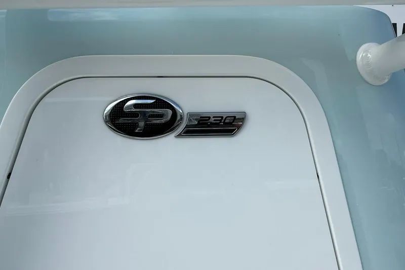 Slide: The Image of 2026 Sea Pro 230 Bay boat emblem on a sleek white surface. - 5