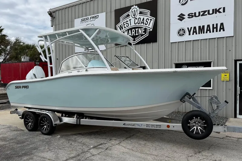 The Image of 2026 Sea Pro 240 Dual Console boat on trailer at West Coast Marine dealership. - 1