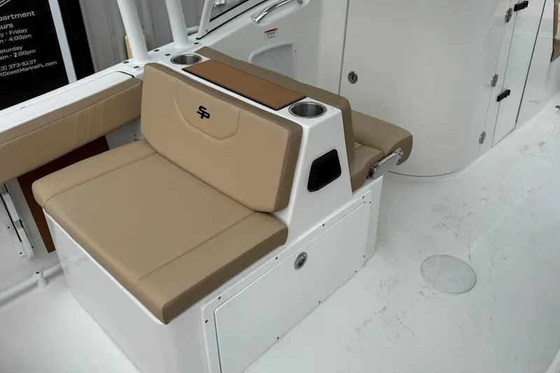 Slide: The Image of 2026 Sea Pro 240 Dual Console boat interior with beige seating and cup holders. - 14