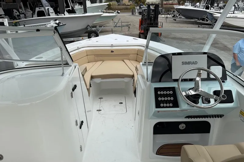 Slide: The Image of 2026 Sea Pro 240 Dual Console boat interior with steering wheel and seating area. - 15