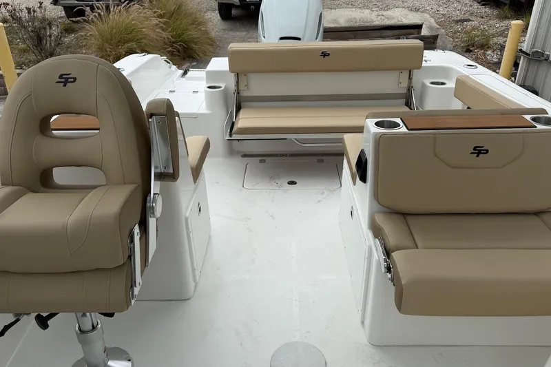 Slide: The Image of 2026 Sea Pro 240 Dual Console boat interior with beige seating and cup holders. - 20