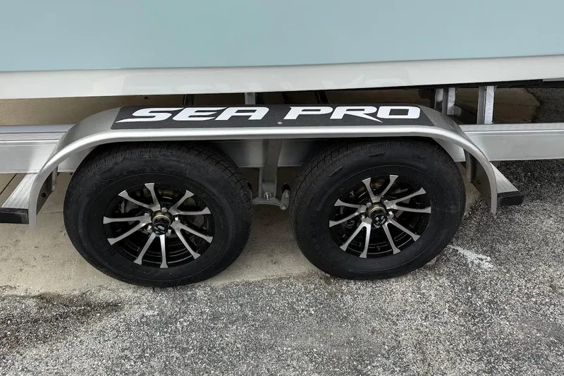 Slide: The Image of Trailer of 2026 Sea Pro 240 Dual Console with stylish black wheels. - 5