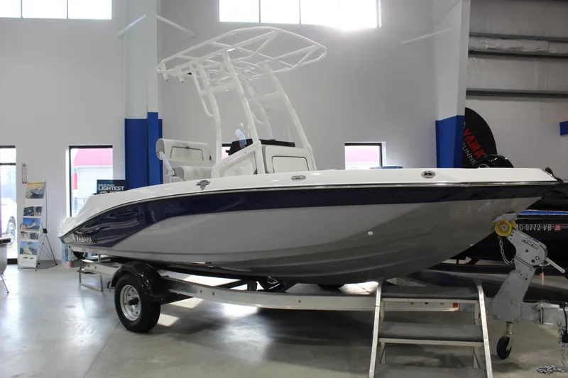 The Image of 2026 Yamaha Boats 195 FSH Sport on trailer in showroom, side view. - 0