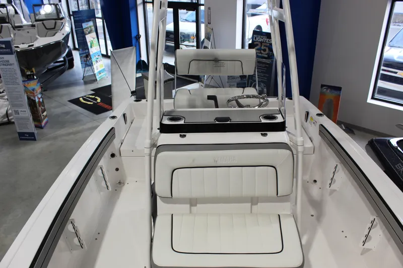 Slide: The Image of 2026 Yamaha Boats 195 FSH Sport interior with white seating and steering console. - 14