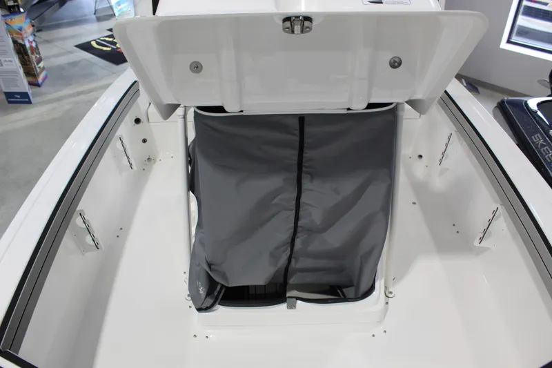 Slide: The Image of 2026 Yamaha Boats 195 FSH Sport storage compartment with open hatch and gray cover. - 15