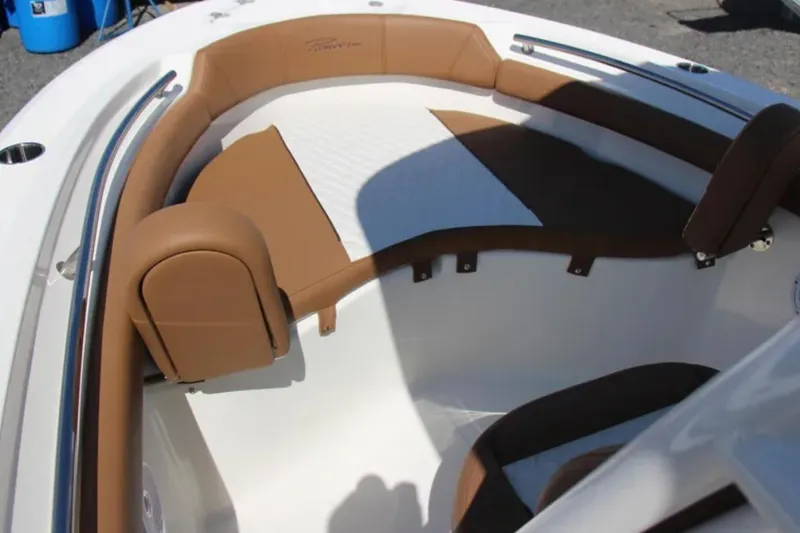 Slide: The Image of 2026 Pioneer 202 Islander boat interior with brown cushioned seating and stainless steel railings. - 11