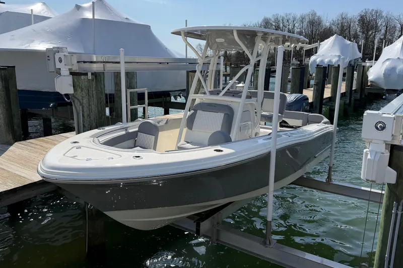 Slide: The Image of 2026 Pioneer 202 Islander boat docked on a lift at a marina. - 15