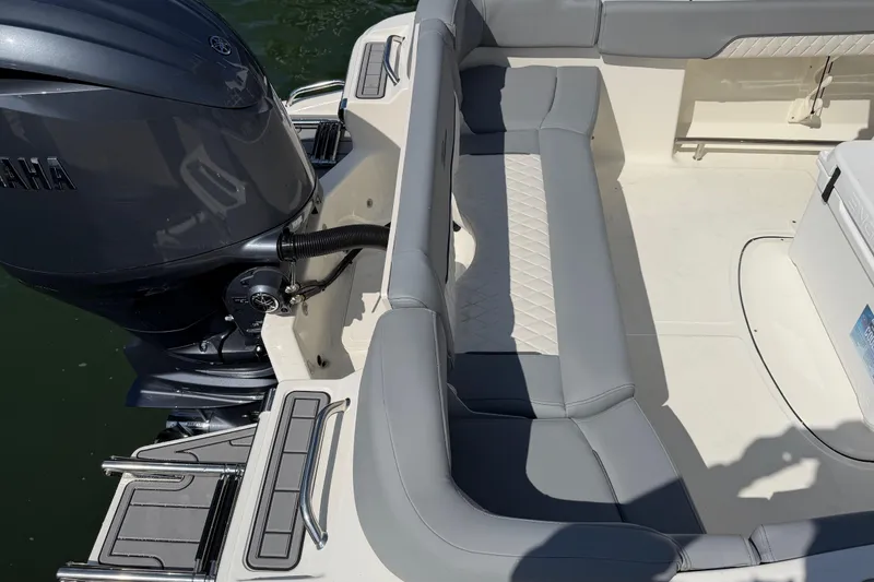 Slide: The Image of 2026 Pioneer 202 Islander boat interior with Yamaha engine, featuring gray seating and deck details. - 18