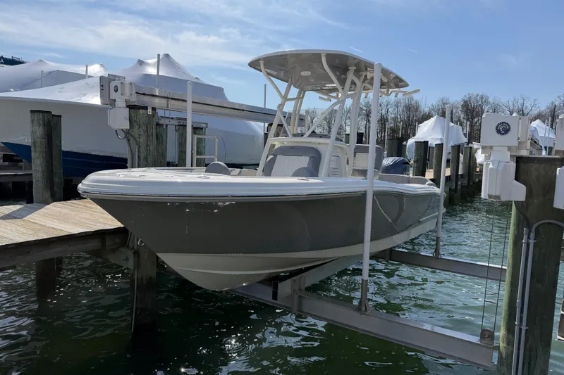 Slide: The Image of 2026 Pioneer 202 Islander boat on lift at marina dock. - 24