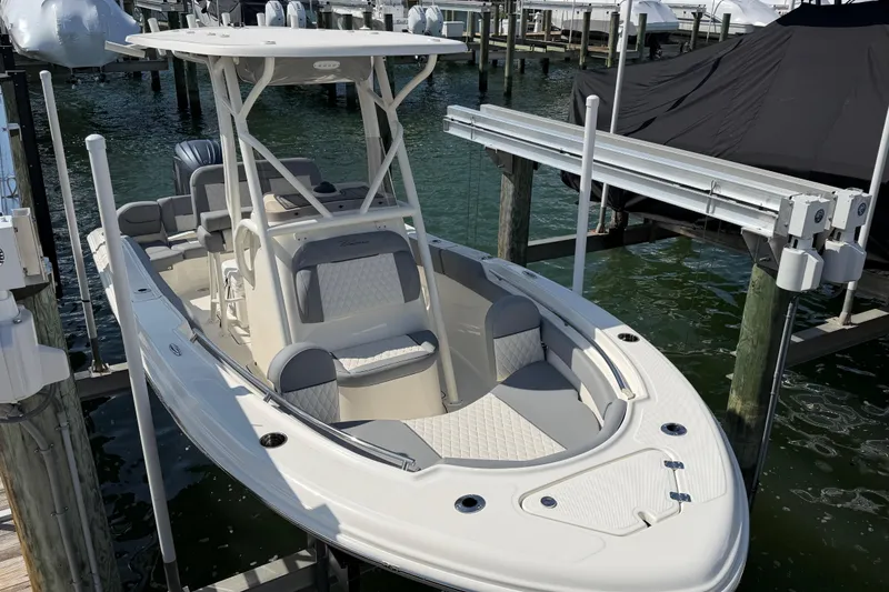 Slide: The Image of 2026 Pioneer 202 Islander boat docked, featuring sleek design and comfortable seating. - 26