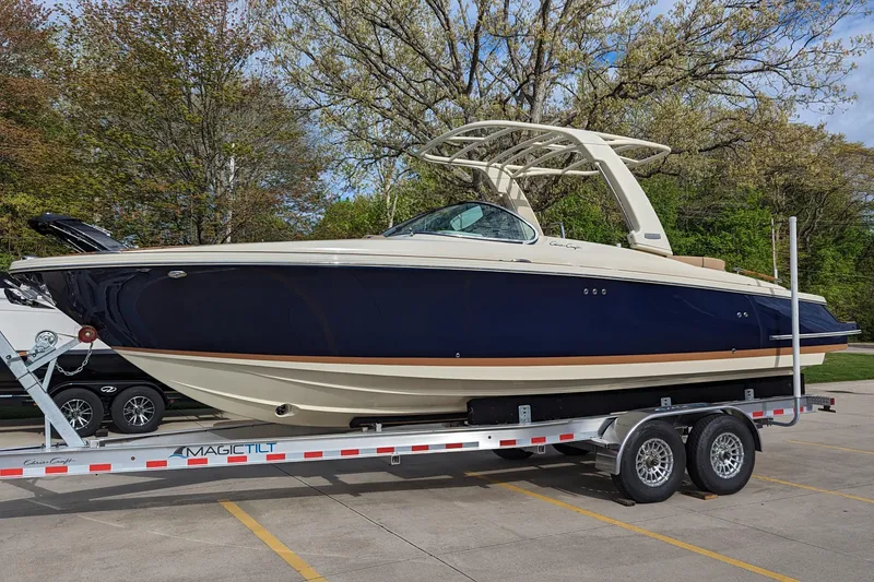 The Image of 2025 Chris-Craft Launch 28 GT boat on trailer, parked outdoors. - 0